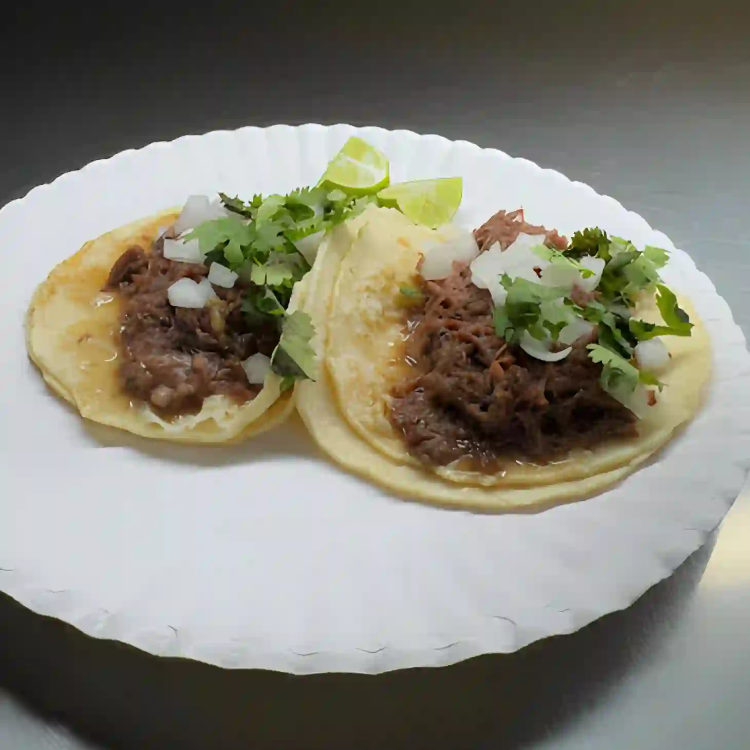 Cabeza - Slow-cooked beef head with rich spices, tender meat, and corn tortillas